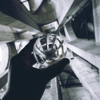 person holding sphere person holding sphere