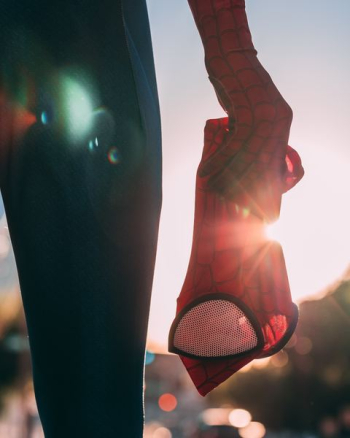 person holding Spider-Man mask person holding Spider-Man mask