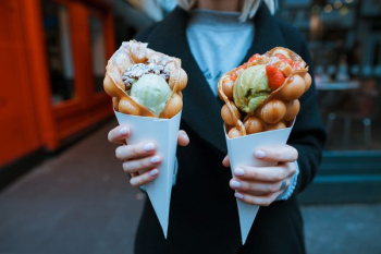 person holding two ice creams person holding two ice creams