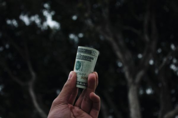 person holding U.S. dollar banknote person holding U.S. dollar banknote