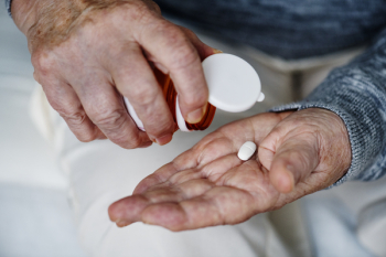 Person Holding White Medication Tablet Person Holding White Medication Tablet