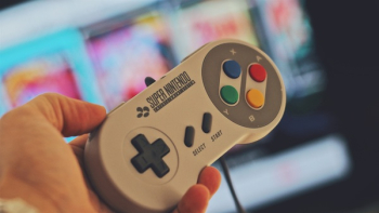 Person Holding White Snes Controller Person Holding White Snes Controller
