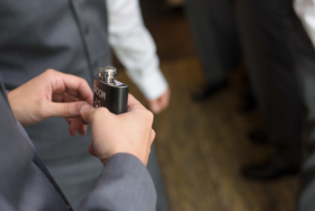 Person Holds Black Hip Flask Person Holds Black Hip Flask