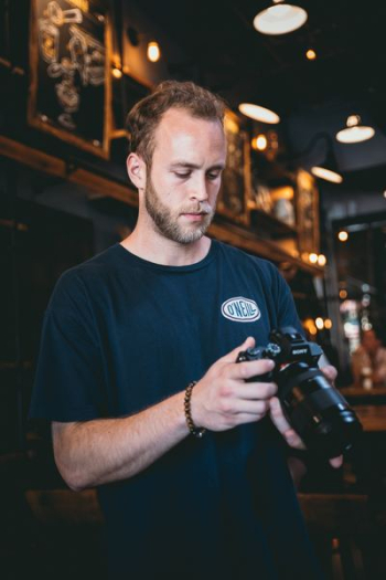 person holds DSLR camera person holds DSLR camera