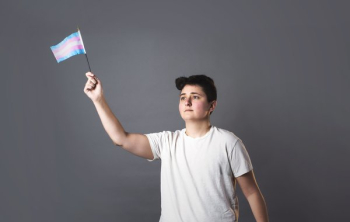 Person Holds Up Trans Pride Flag Person Holds Up Trans Pride Flag