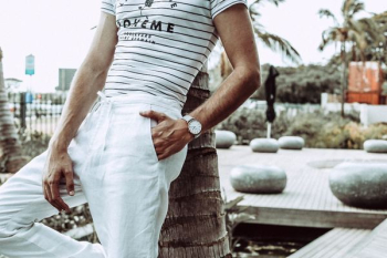 person in white pants wearing white analog watch person in white pants wearing white analog watch