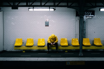 Person in Yellow Jacket on Yellow Chair at Metro Station · Free Stock Photo