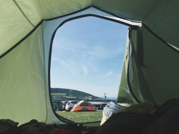 person inside tent with gray and orange tent background outside person inside tent with gray and orange tent background outside
