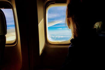 person looking outside of airplane window person looking outside of airplane window