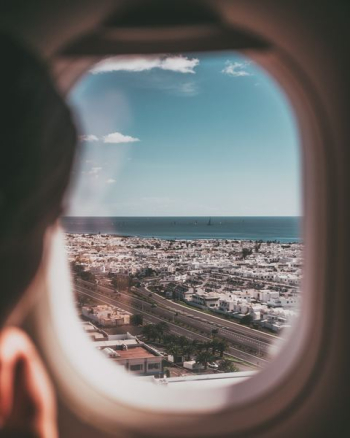 person near airplane window person near airplane window
