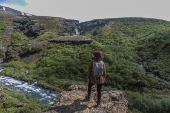 Person Near Cliff Above Stream Person Near Cliff Above Stream