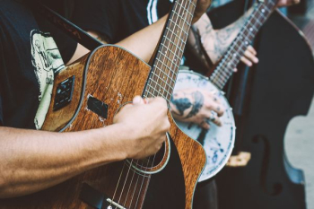 person playing acoustic guitar person playing acoustic guitar