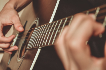 Person Playing Brown Acoustic Guitar Person Playing Brown Acoustic Guitar