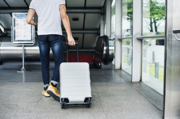 Person Pulling Travel Luggage Person Pulling Travel Luggage