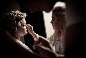 Person Putting Makeup On Woman