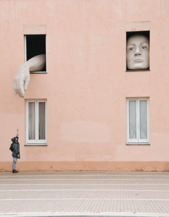 person raising hand under the window person raising hand under the window
