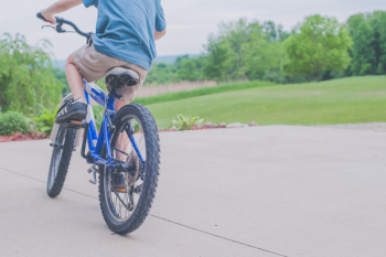 Person Riding Blue Bicycle