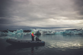 person riding boat while fishing person riding boat while fishing