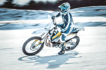 person riding on black and white motocross dirt bike person riding on black and white motocross dirt bike