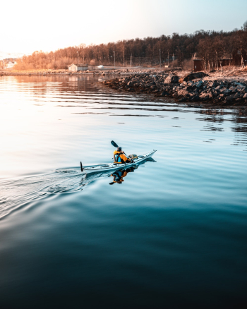 Person Riding on Kayak Person Riding on Kayak