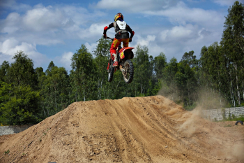 Person Riding Red Dirk Bike Mid Air Ramping Person Riding Red Dirk Bike Mid Air Ramping