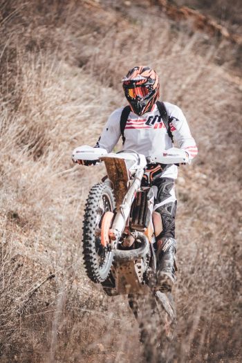 Person Riding White Dirt Bike Mid Air Person Riding White Dirt Bike Mid Air