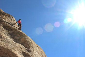 person rock climbing during day time person rock climbing during day time