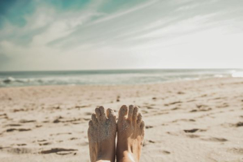 person's feet covered with sand person's feet covered with sand