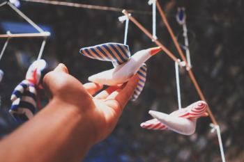 person's hand holding bird decor person's hand holding bird decor