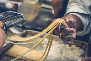 person sheeting dough person sheeting dough