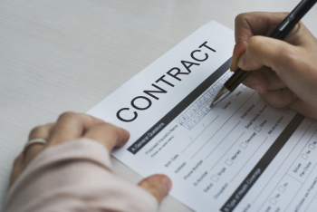 Person Signing Contract Paper Person Signing Contract Paper