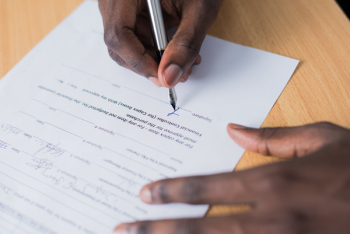 Person Signing Paper Person Signing Paper