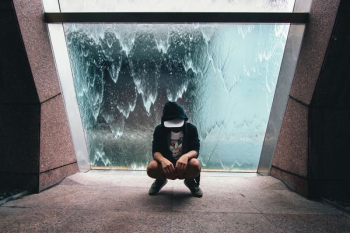 person sitting near glass window person sitting near glass window