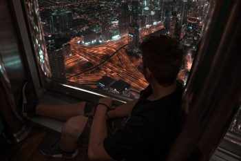 Person Sitting Near Glass Window Person Sitting Near Glass Window