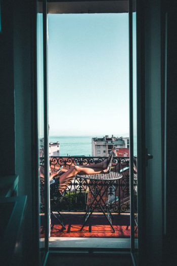 person sitting on balcony person sitting on balcony