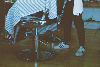 Person Sitting on Barber's Chair Person Sitting on Barber's Chair