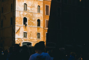 person sitting on building window person sitting on building window