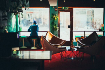 person sitting while facing window person sitting while facing window