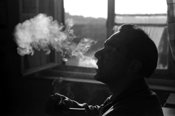 person smoking beside window person smoking beside window