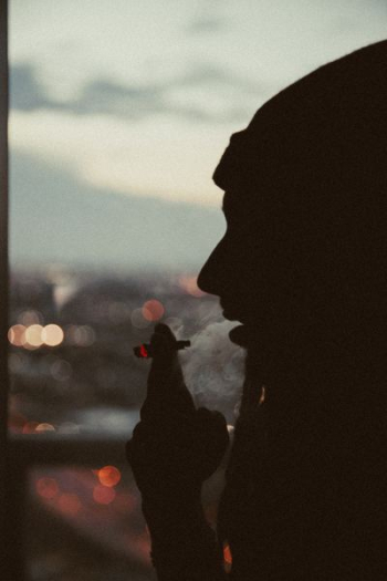 person smoking marijana joint person smoking marijana joint