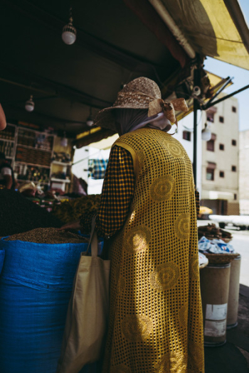 Person Standing Beside Blue Sack Person Standing Beside Blue Sack