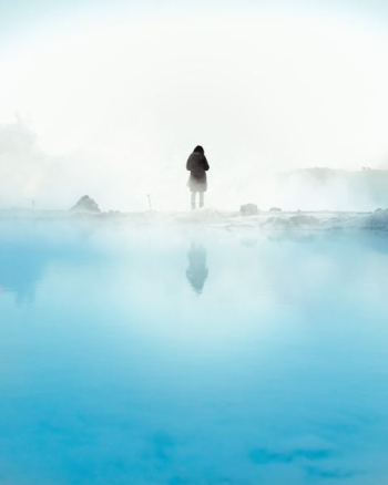 person standing beside body of water during daytime