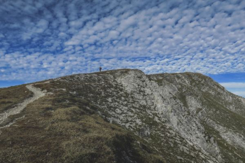 person standing on mountain during daytime person standing on mountain during daytime