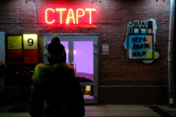 person standing on neon sigange person standing on neon sigange