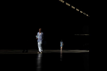 person standing on platform in dark area person standing on platform in dark area