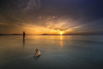 Person Standing on Shallow Water during Golden Hour Person Standing on Shallow Water during Golden Hour