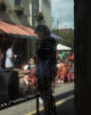 person standing outside glass window person standing outside glass window