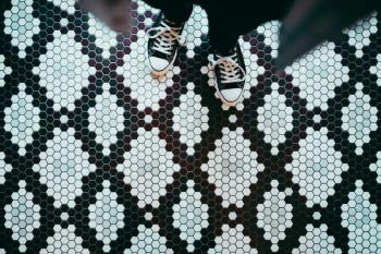 person standing wearing black sneakers person standing wearing black sneakers