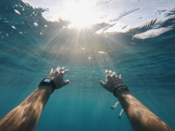 person swimming in sea person swimming in sea