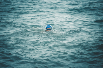 Person Swimming on Sea Person Swimming on Sea